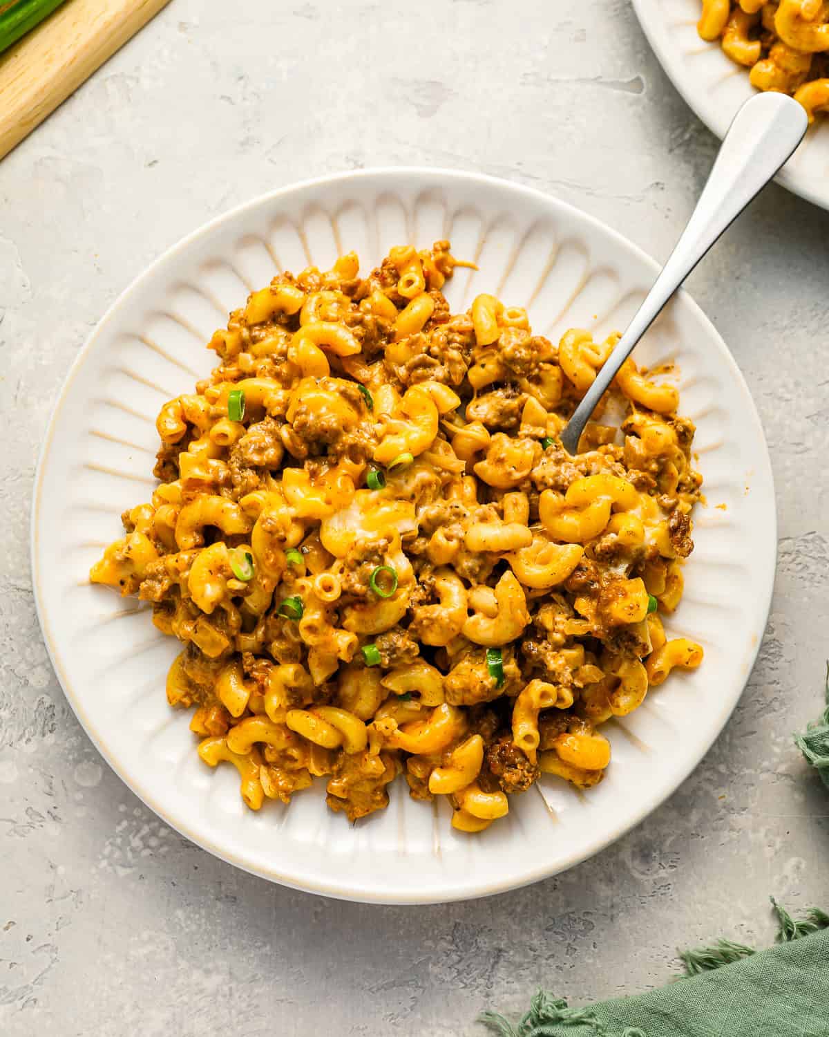 A serving of cheeseburger casserole on a white plate.