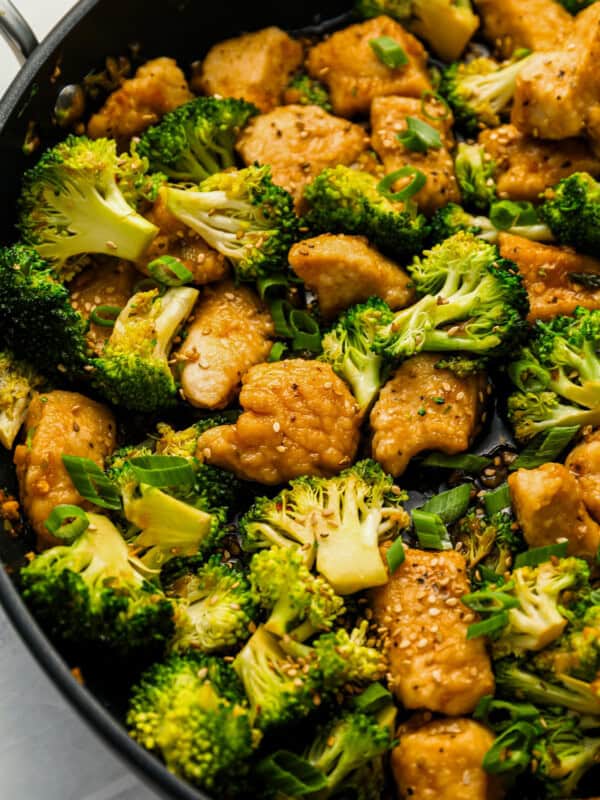 Close up on a stir fry with chicken and broccoli.