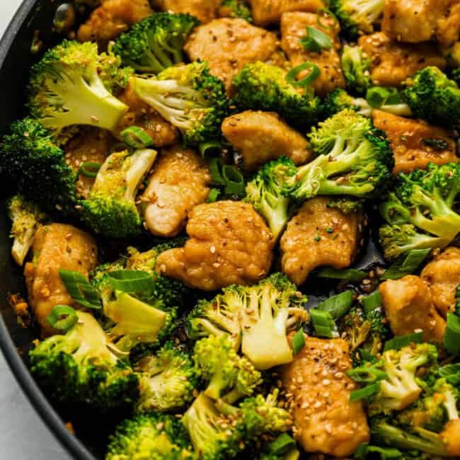 Close up on a stir fry with chicken and broccoli.