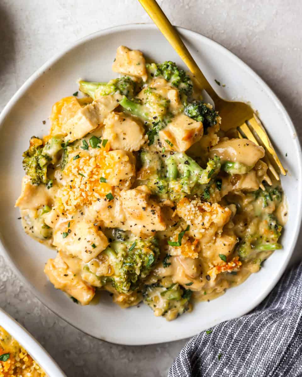 a serving of creamy chicken divan casserole on a plate with a fork.