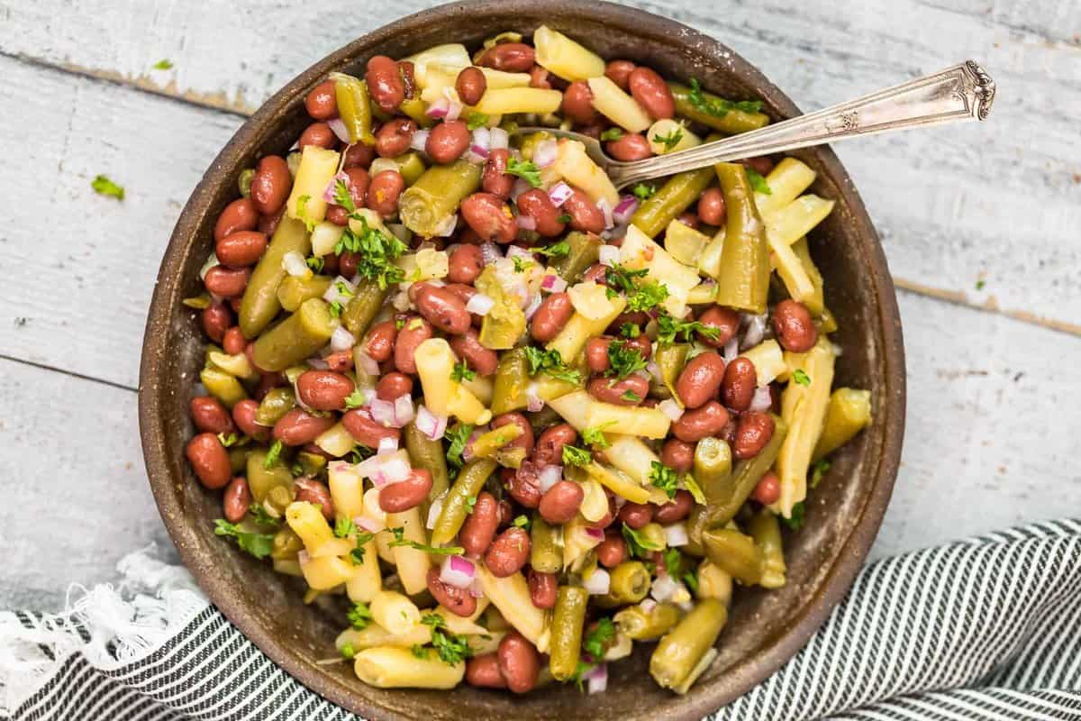 three bean salad in bowl with spoon