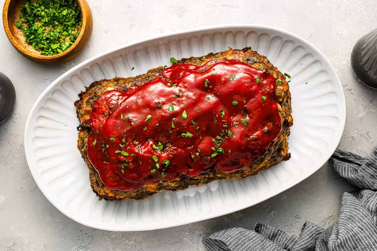 overhead view of cracker barrel meatloaf on a white serving platter.