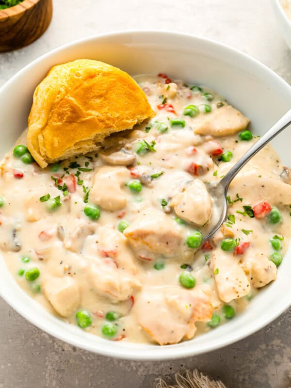 A bowl of Chicken a la King with peas and mushrooms.