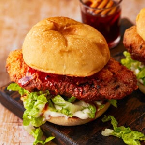 a hot honey chicken sandwich on a black plate.