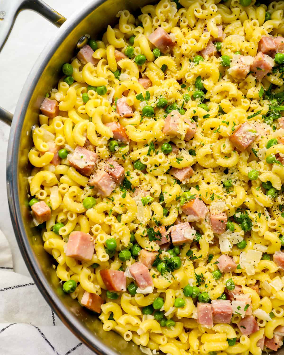 partial overhead view of ham and pea pasta in a pan.