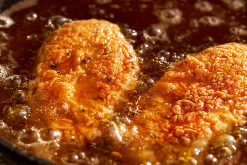 frying chicken breasts in oil.