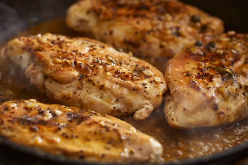 close up of lemon pepper chicken in a pan.