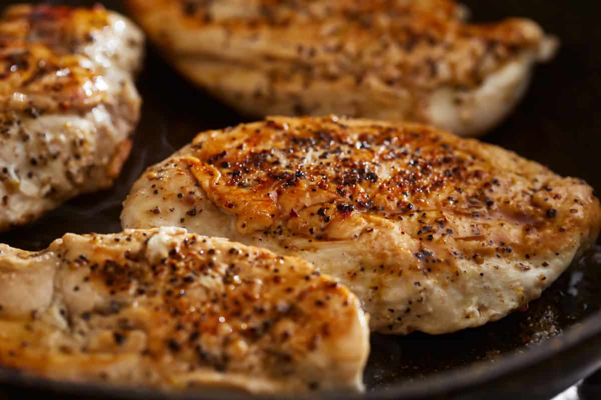 cooking chicken breasts in a pan.