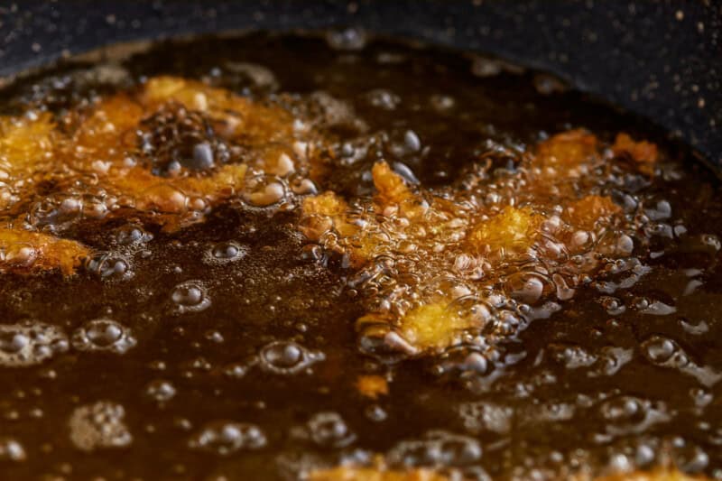 frying breaded shrimp in oil.