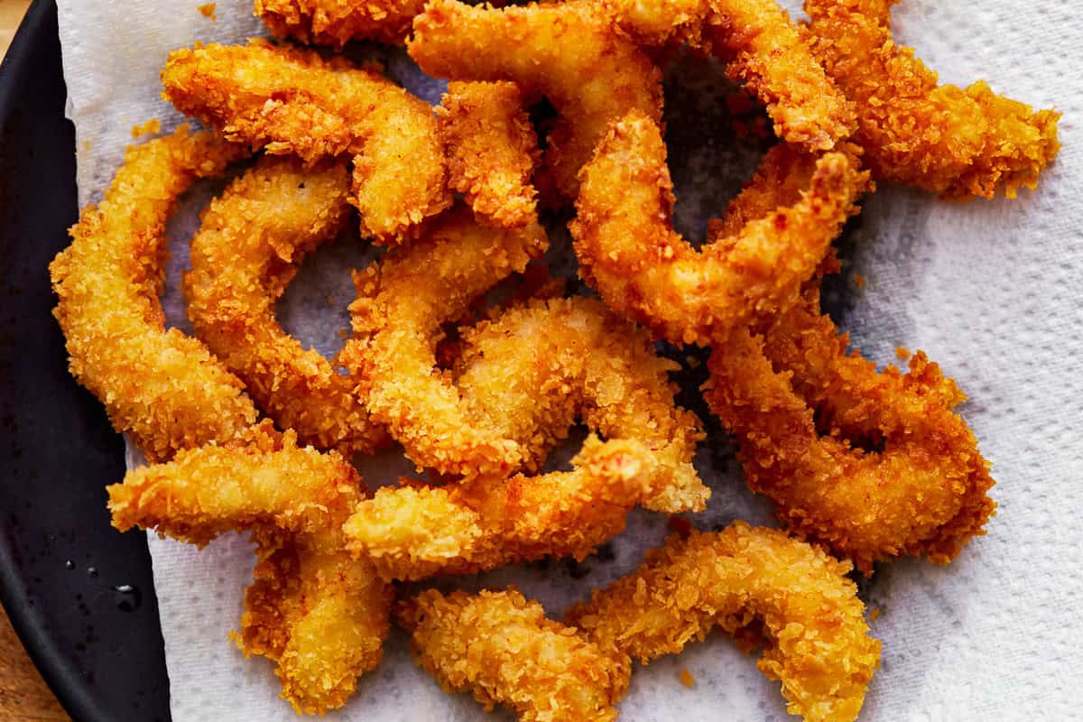 popcorn shrimp on a paper towel-lined baking sheet.