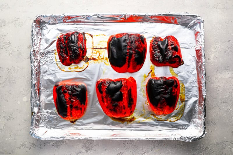 roasted red peppers on a baking sheet.