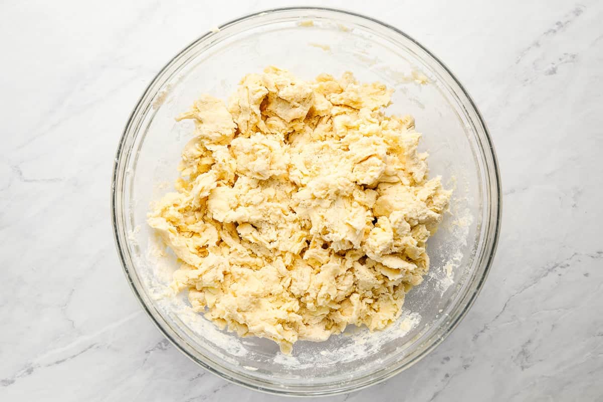 rough biscuit dough in a glass bowl.