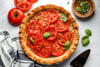 baked tomato pie topped with basil.