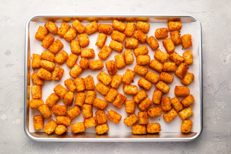 cooked tater tots on a baking sheet.