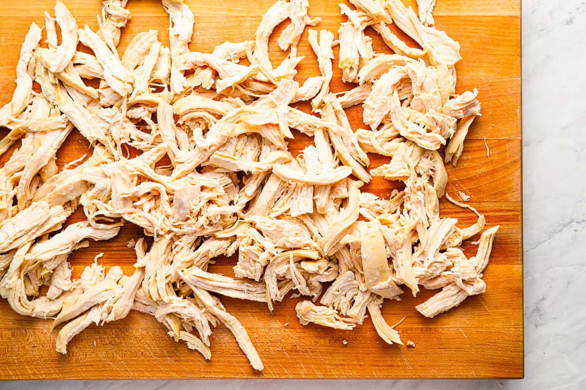 shredded chicken on a cutting board.