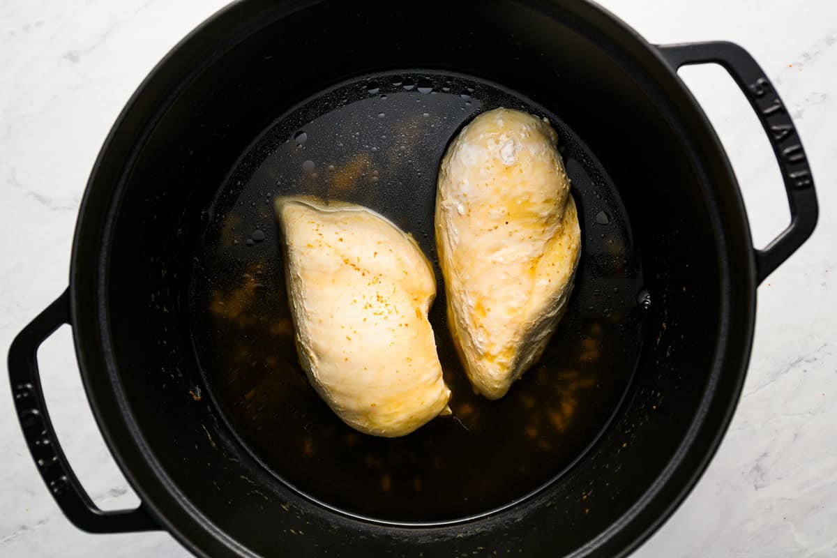 poached chicken breasts in a dutch oven.