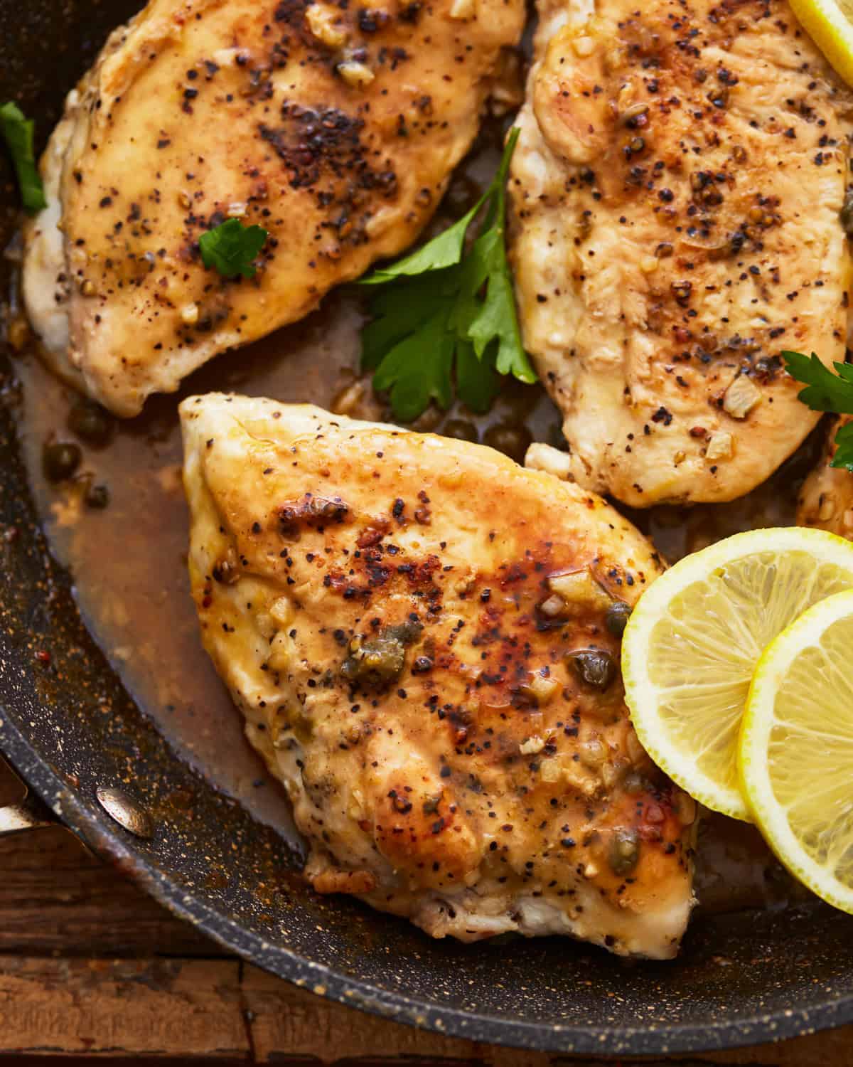 close up of lemon pepper chicken in a pan.