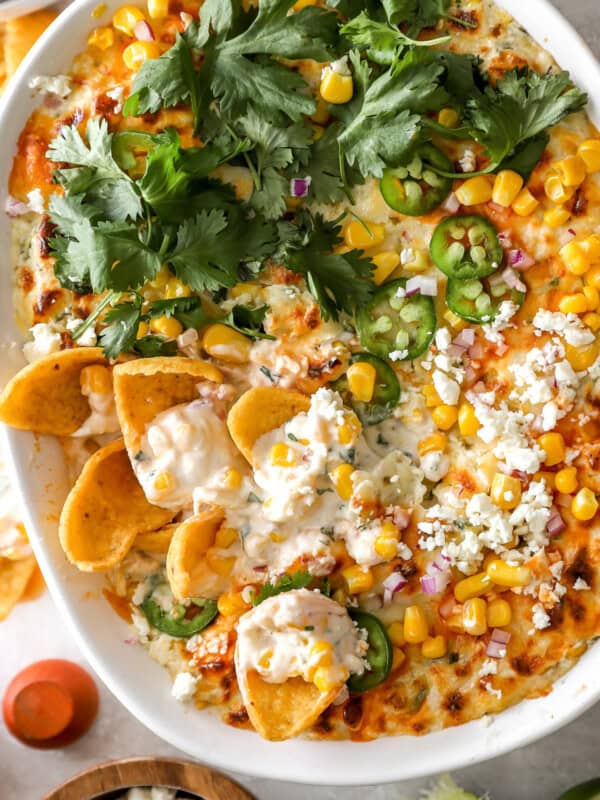 overhead view of mexican street corn dip in an oval baking dish.