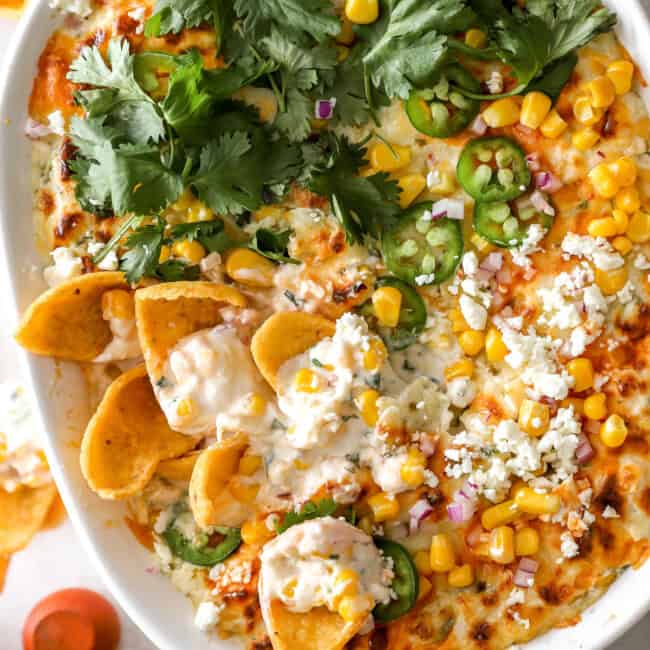 overhead view of mexican street corn dip in an oval baking dish.