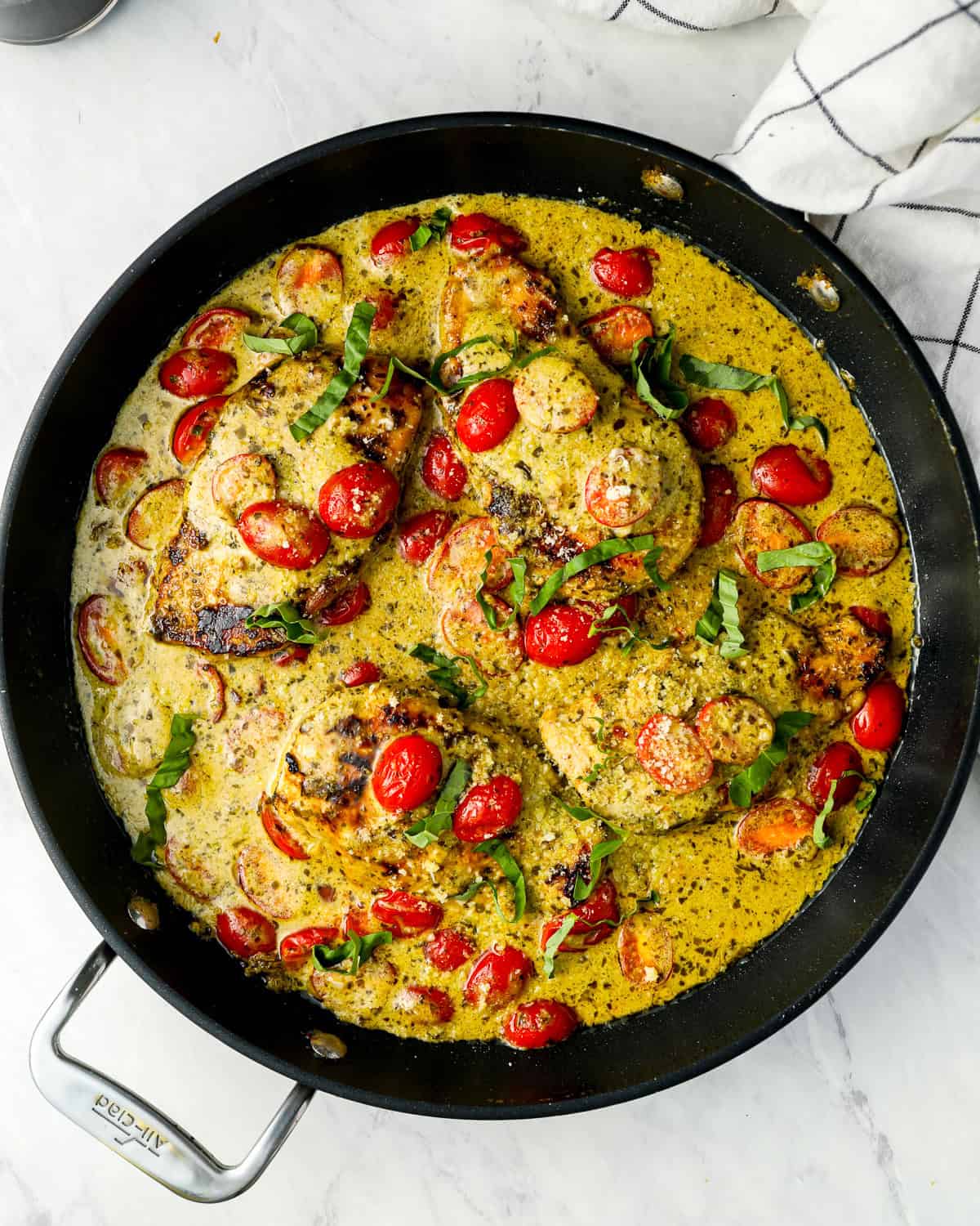 overhead view of pesto chicken in a skillet.