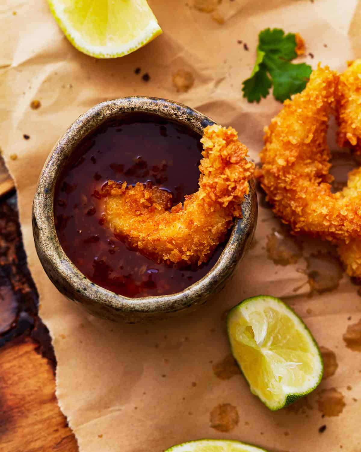 a popcorn shrimp dipped in cocktail sauce.