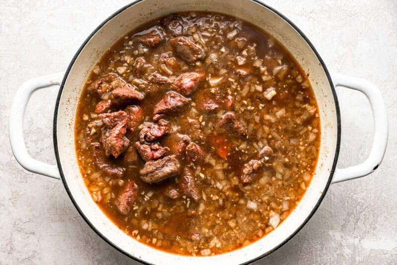 Beef tips and brown gravy in a pot.