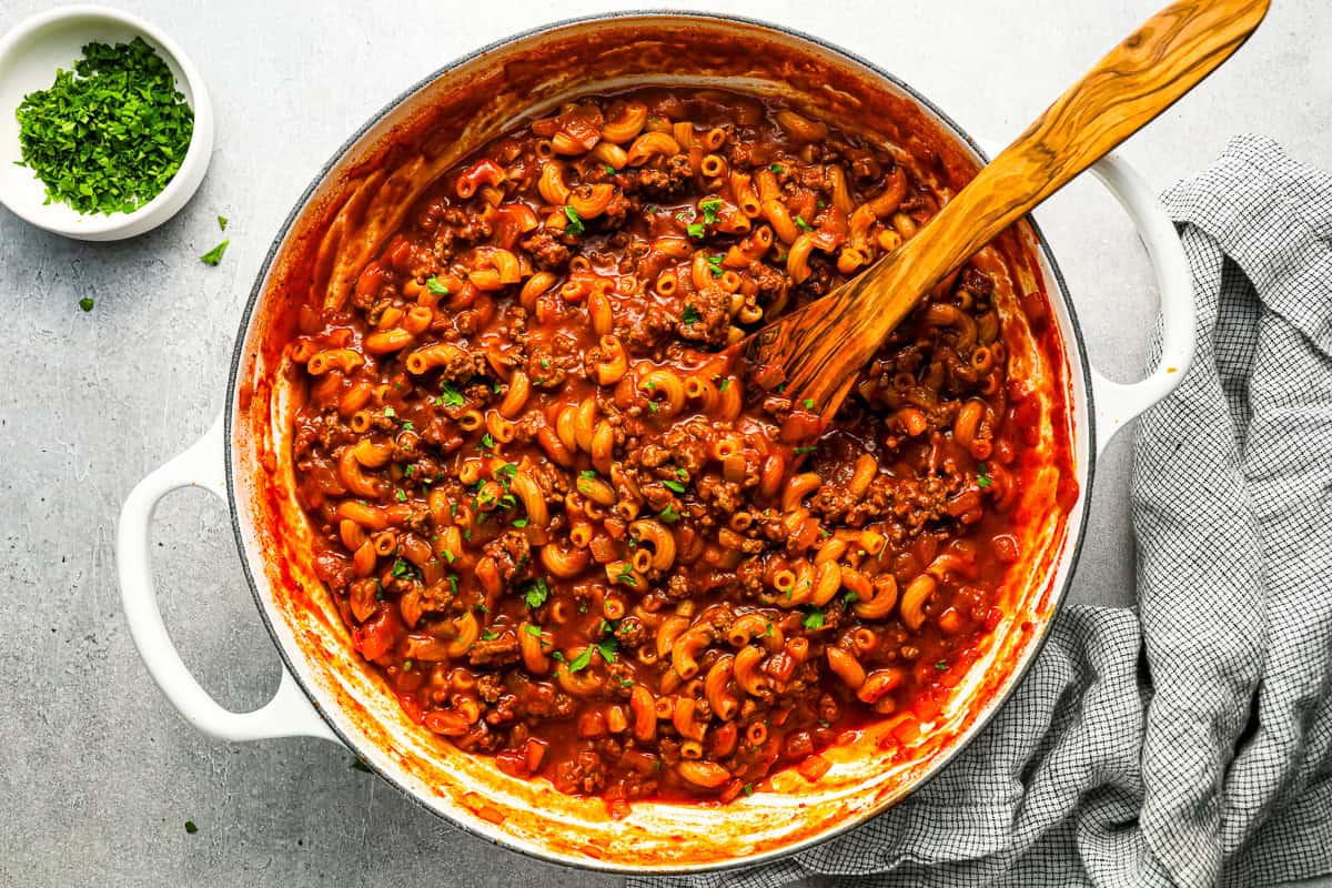 overhead view of beefaroni cooking in a white pot.