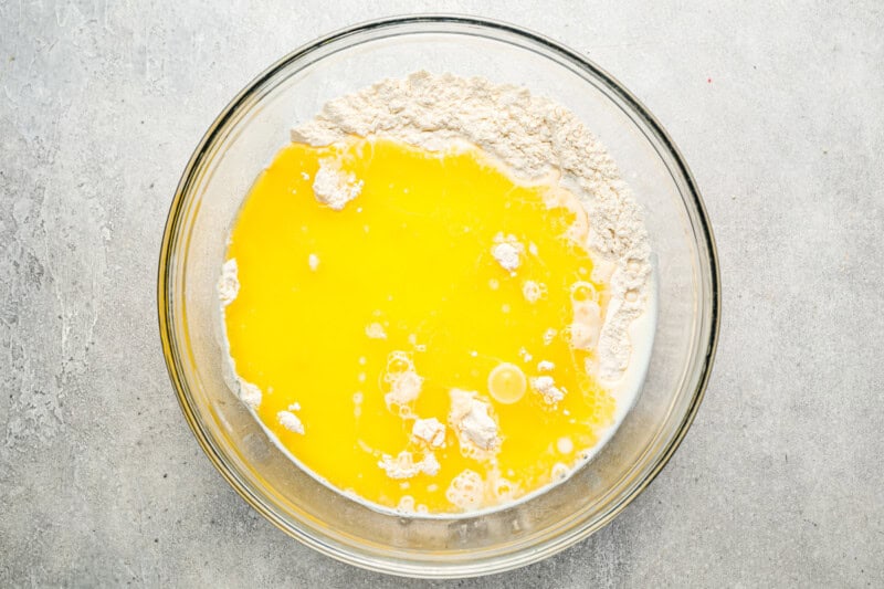 Flour and melted butter in a large glass mixing bowl.