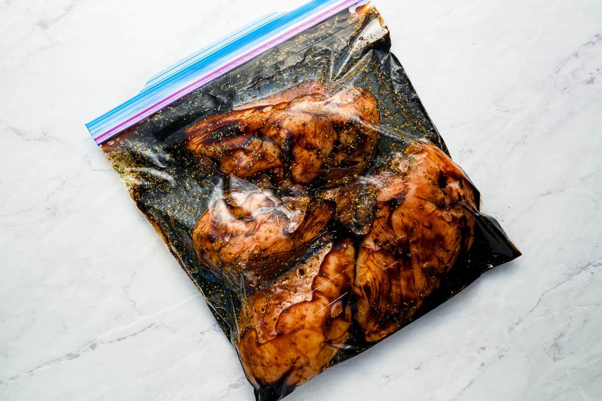 Chicken breasts marinating in a resealable bag.