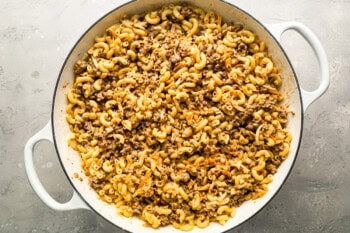 cheeseburger casserole assembled in a large white pot.