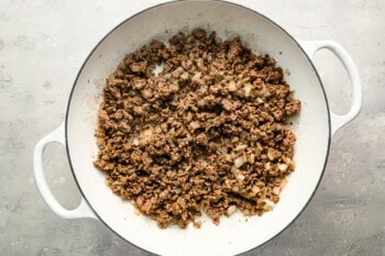 ground beef and onion cooking in a large pot.