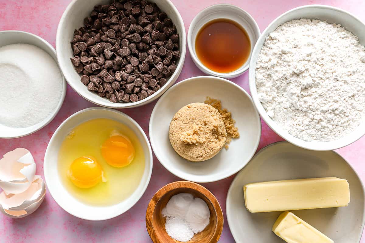 Ingredients for a chocolate chip cookie cake, separated into bowls.