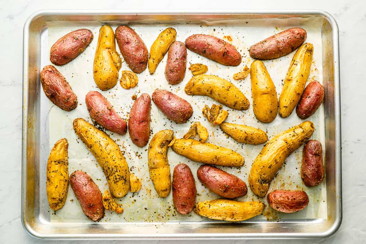 halved fingerling potatoes cut side down on a baking sheet.