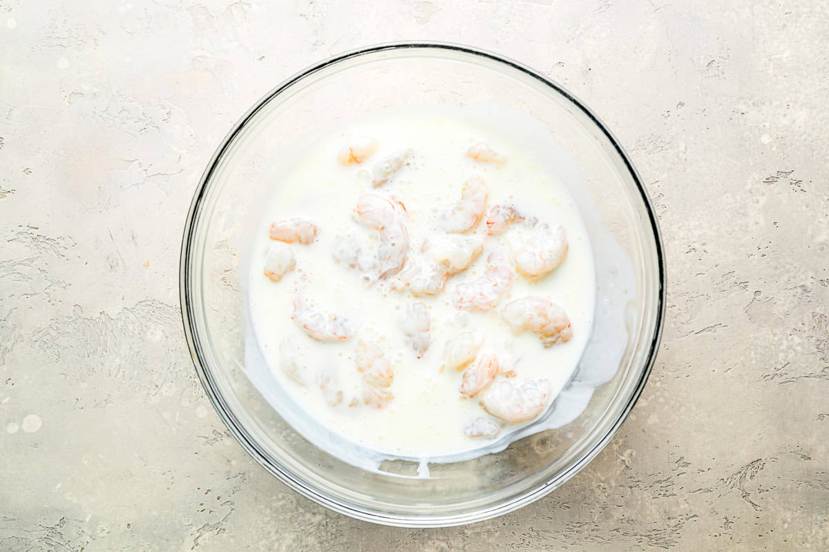 shrimp in buttermilk in a bowl.