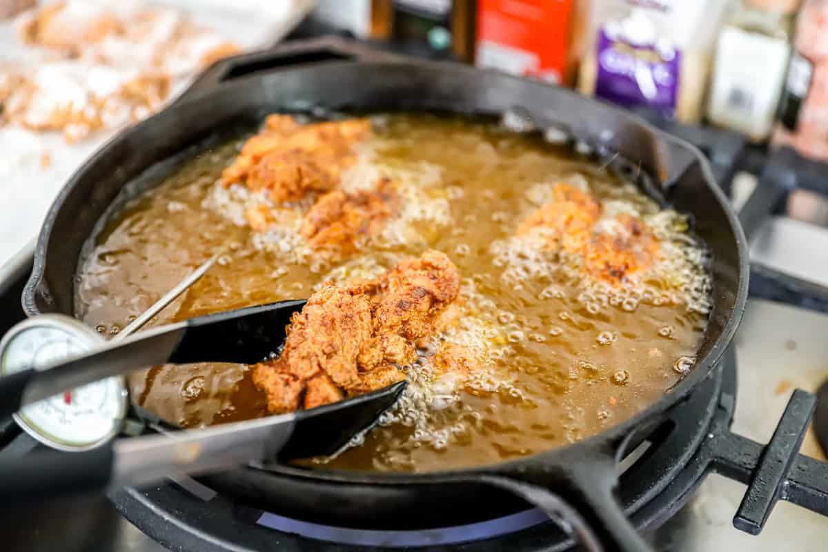 frying chicken in a skillet.