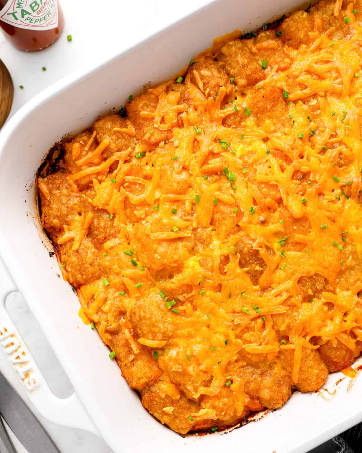 partial overhead view of tater tot breakfast casserole in a baking dish.