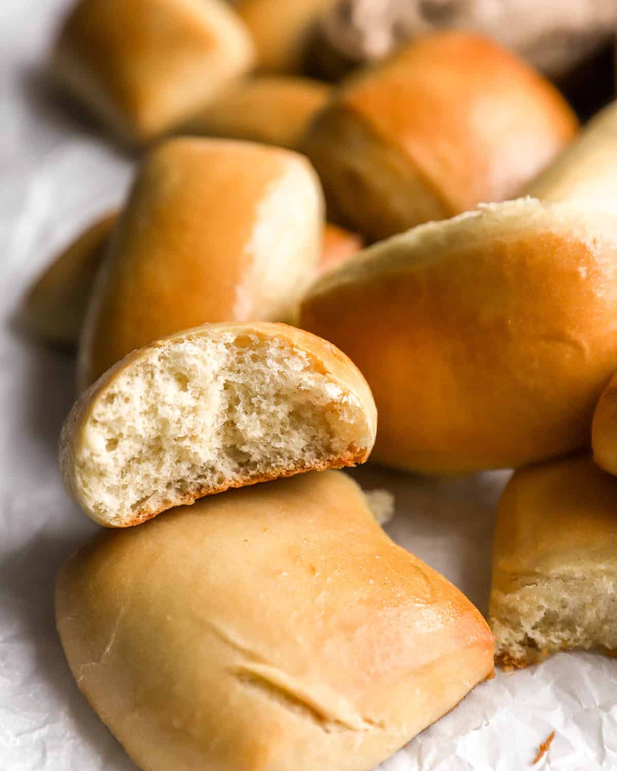 close up of a partially eaten texas roadhouse roll resting on another roll.