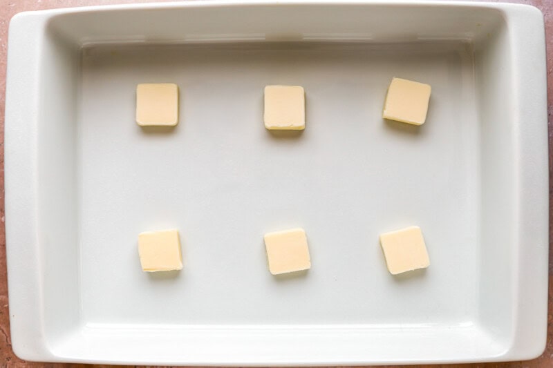 squares of butter in a baking pan.