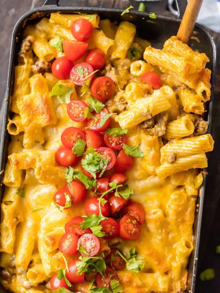 MEXICAN MAC AND CHEESE can't be beat! No need to fool with a tricky cheese sauce when you have this secret ingredient making things extra creamy and delicious. Spicy sausage and green chiles make this baked macaroni and cheese recipe soooo tasty!