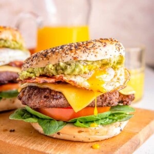 breakfast burgers on a wooden cutting board.