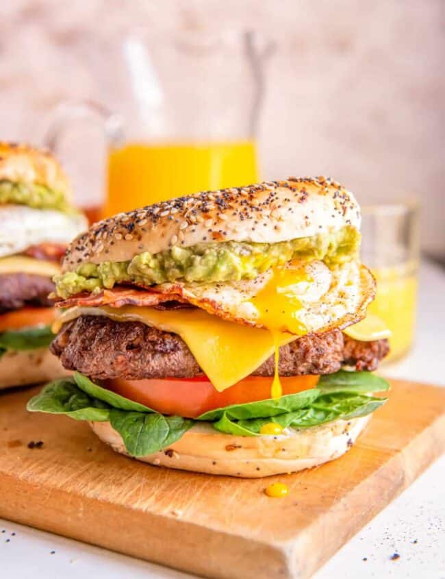 breakfast burgers on a wooden cutting board.