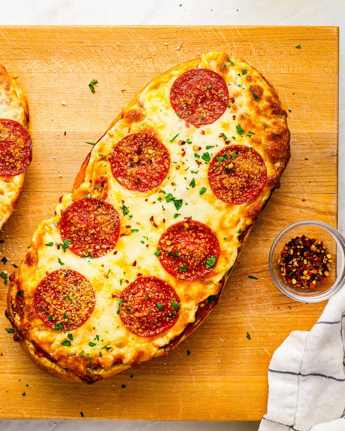 French bread garlic butter pizza with cheese and pepperonis.