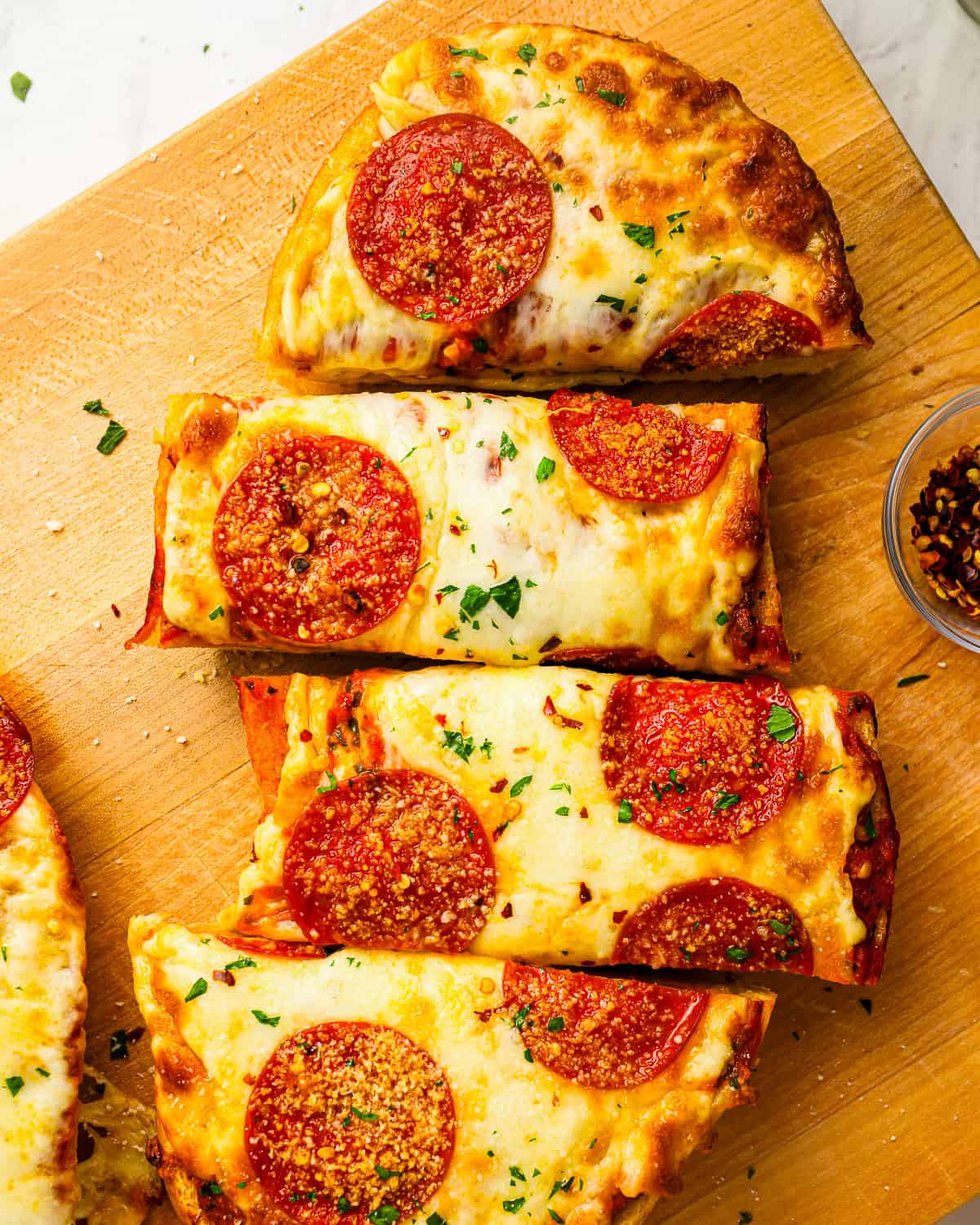 Pepperoni garlic bread pizza cut into slices.