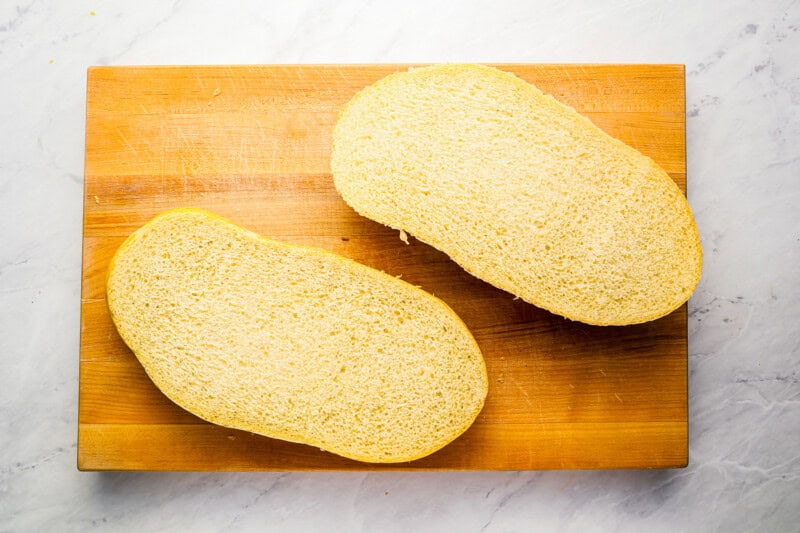 2 slices of French bread on a cutting board.