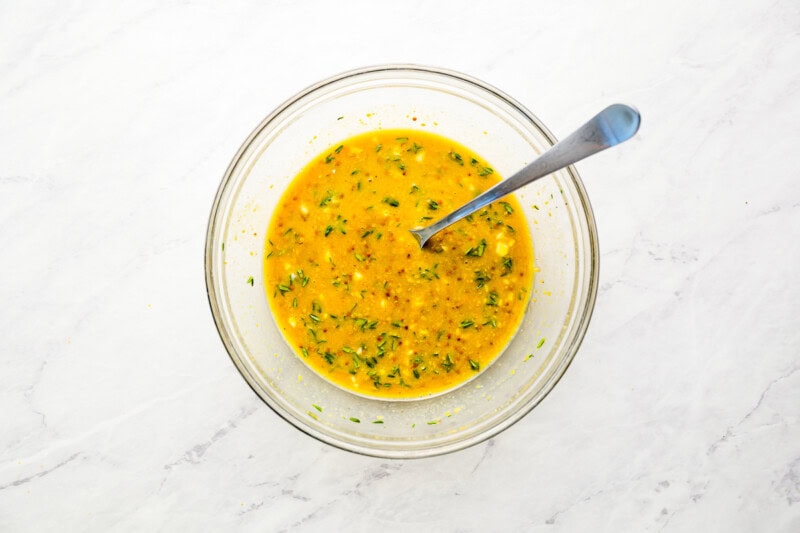 honey mustard sauce in a glass bowl with a spoon.