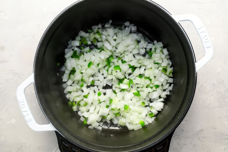 sauteeing onion and jalapeno in a dutch oven.