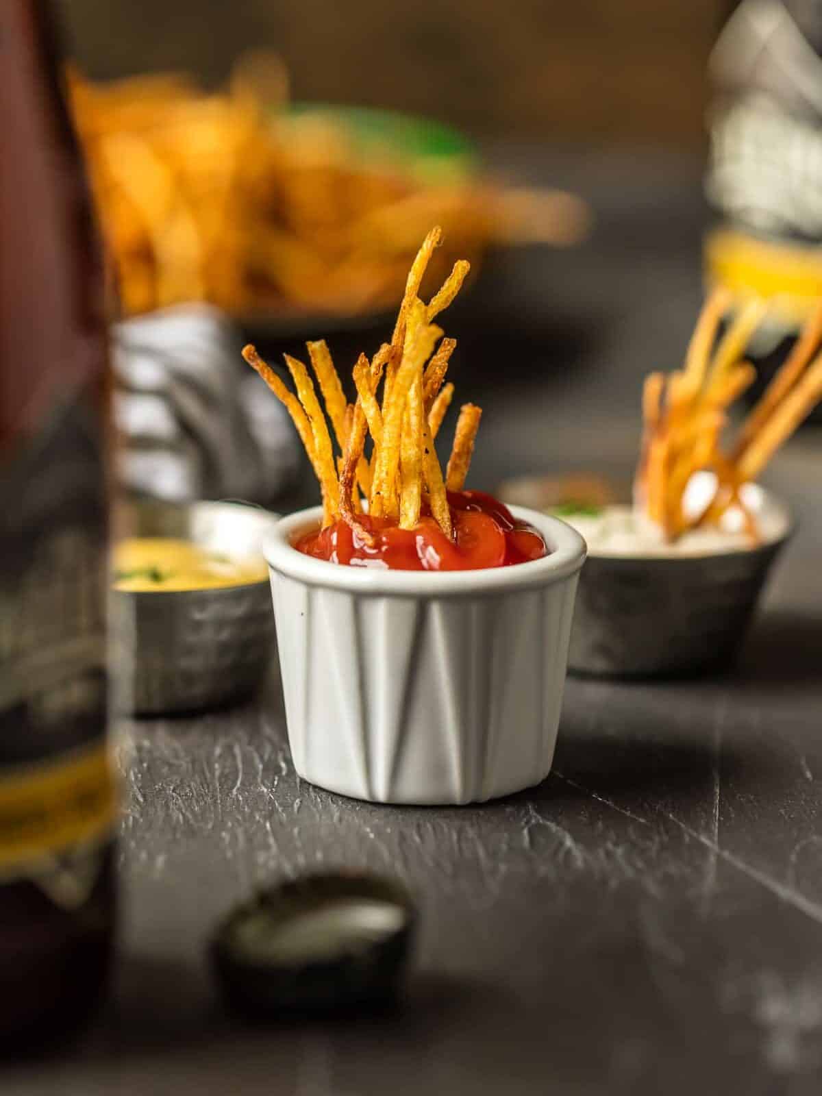 Shoestring Fries dipped in ketchup.