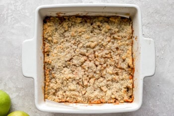 baked apple pie bars in a square baking dish.