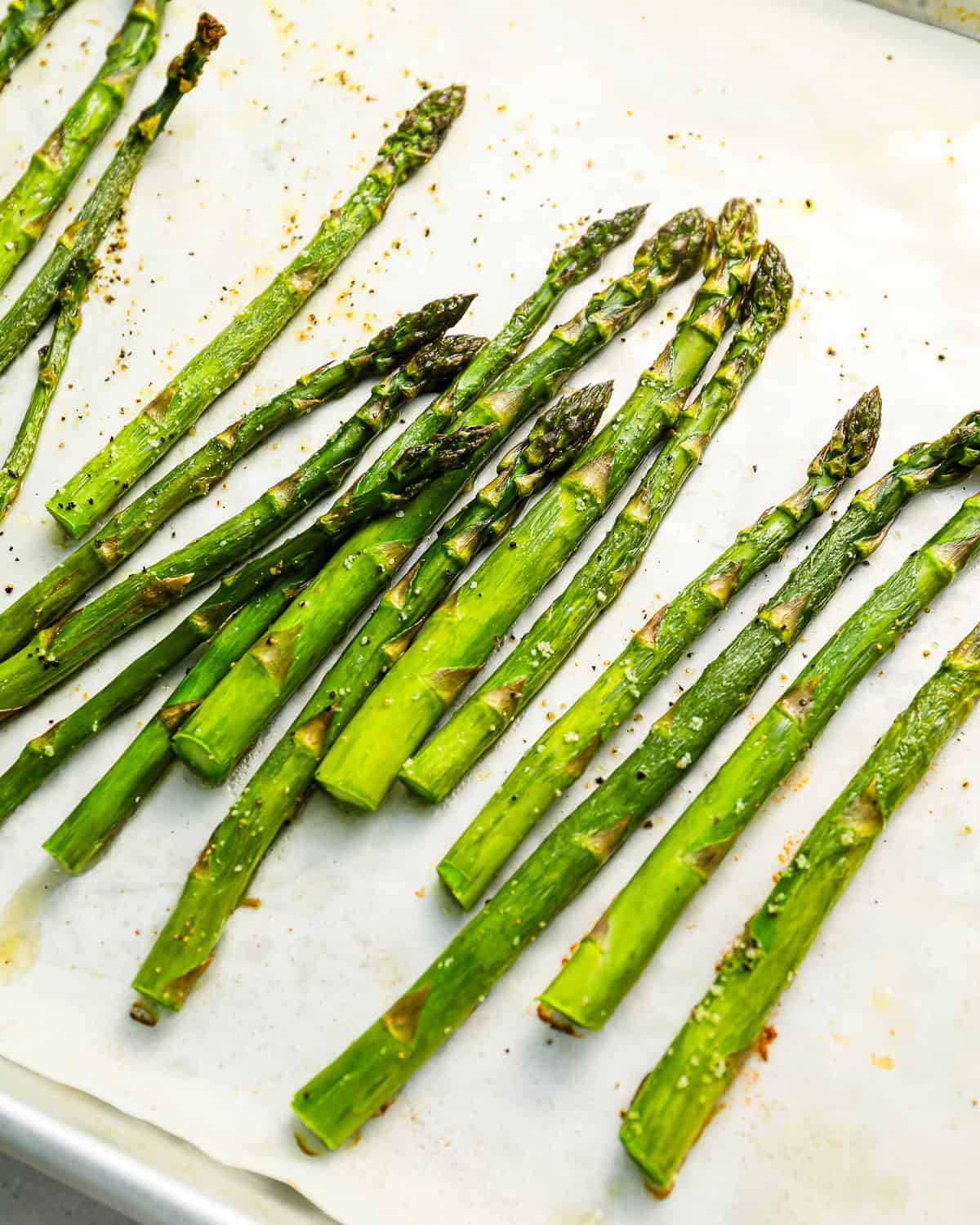 baked asparagus on a baking sheet.