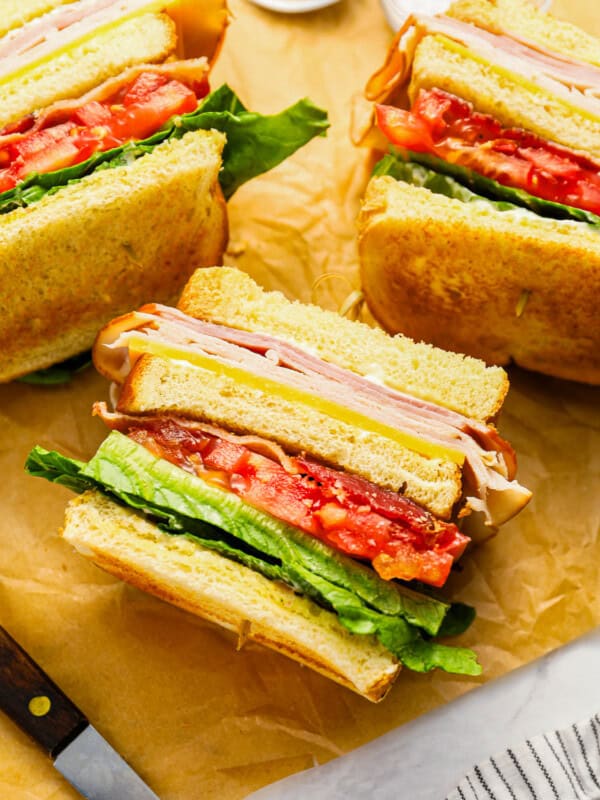 overhead view of club sandwiches turned on their sides to show the layers.